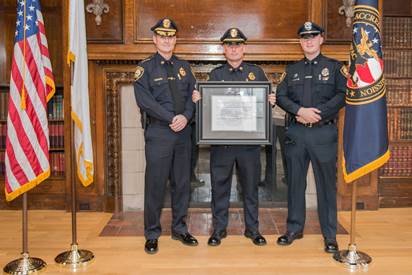 Chief Conley, Lt. Fitzgerald and Officer Machain receiving the MPD's certification award.